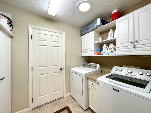 clothes washing area featuring a textured ceiling, cabinets, independent washer and dryer, and light tile patterned flooring