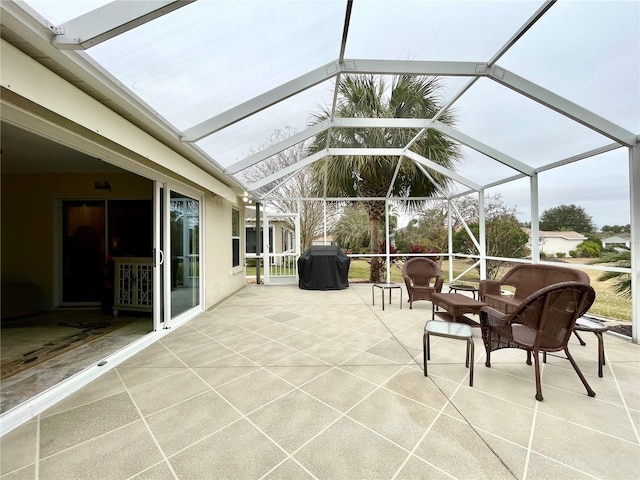 view of patio / terrace featuring a grill and glass enclosure