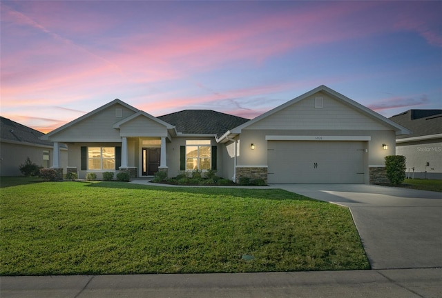 view of front of home featuring a garage and a yard