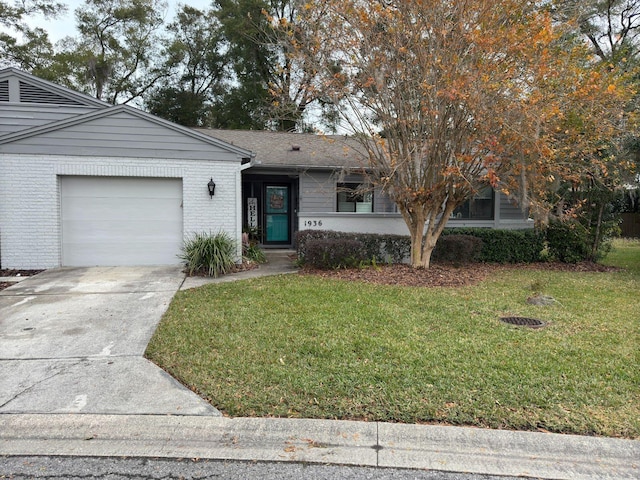 view of front facade with a front yard and a garage