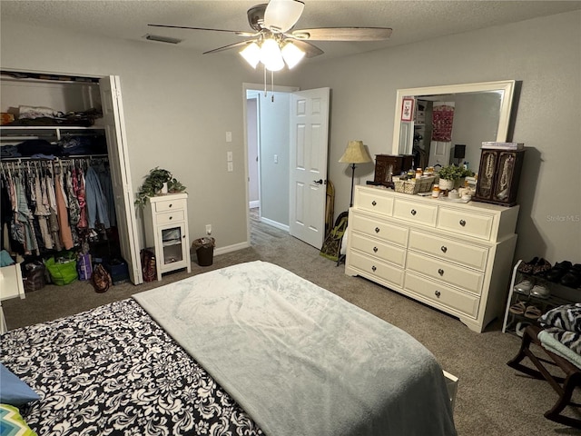 bedroom featuring a textured ceiling, a closet, dark colored carpet, and ceiling fan