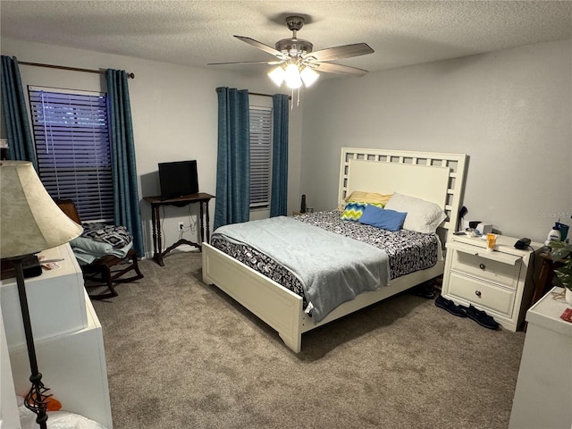 carpeted bedroom featuring ceiling fan and a textured ceiling