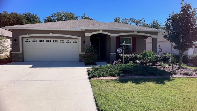 ranch-style home with a garage and a front yard