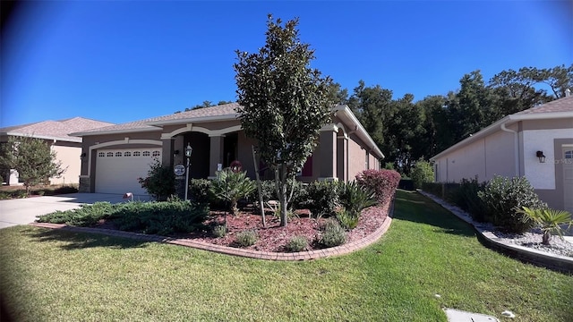 view of front facade with a garage and a front lawn