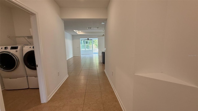 hall featuring washer and dryer and light tile patterned floors