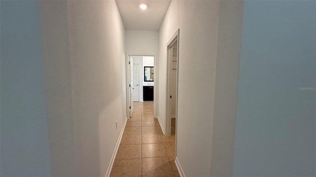 corridor featuring light tile patterned floors