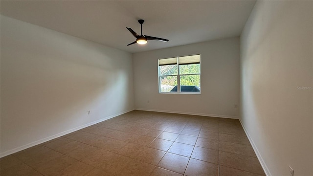 empty room featuring ceiling fan and light tile patterned floors