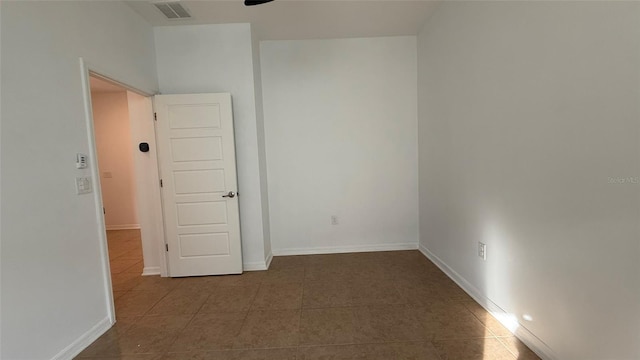 unfurnished room featuring ceiling fan and tile patterned floors