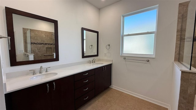 bathroom featuring vanity, tile patterned floors, and walk in shower