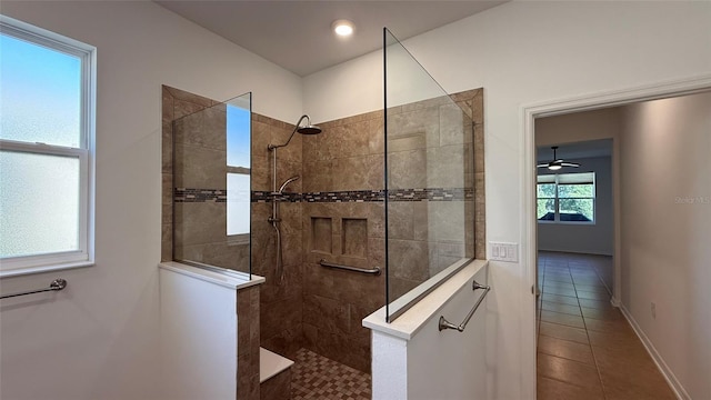 bathroom featuring a tile shower and tile patterned flooring