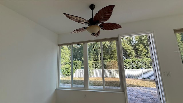 doorway featuring a healthy amount of sunlight and ceiling fan