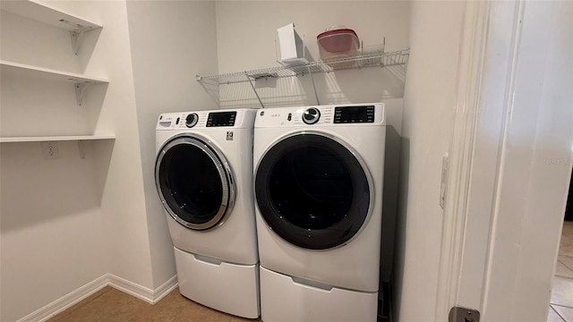 washroom with washing machine and clothes dryer