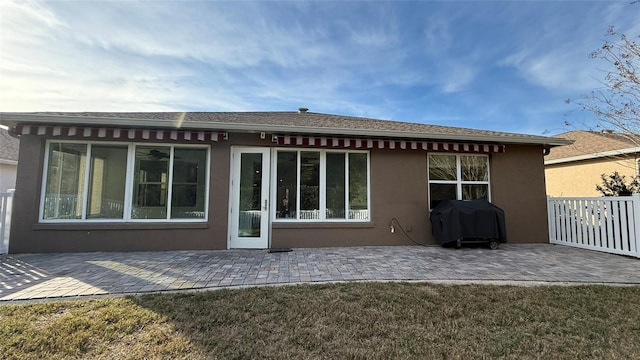 back of property featuring a yard and a patio