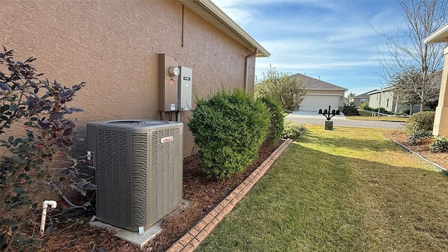 view of side of property with central AC and a yard