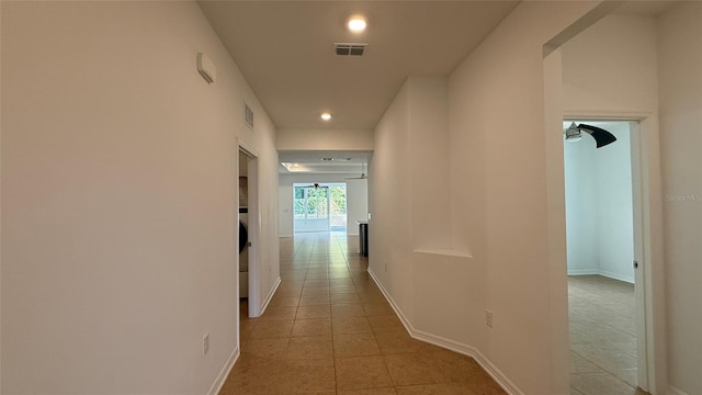 hall with light tile patterned flooring