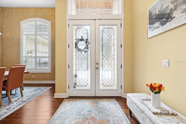 entryway with dark hardwood / wood-style floors and french doors