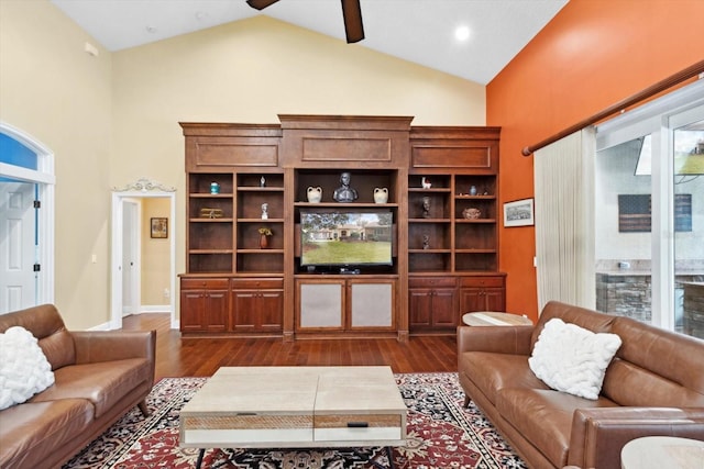 living room with ceiling fan, dark hardwood / wood-style floors, and high vaulted ceiling