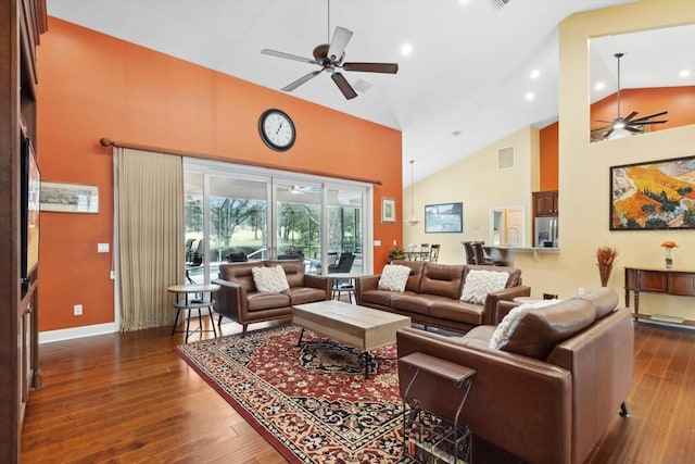 living room featuring dark wood-type flooring, ceiling fan, and high vaulted ceiling