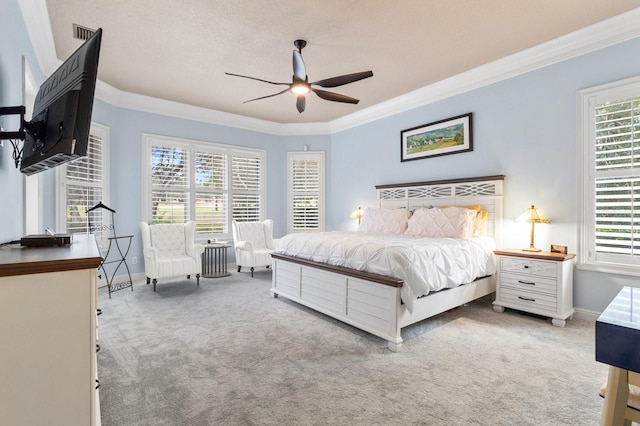 bedroom featuring crown molding, light colored carpet, and ceiling fan