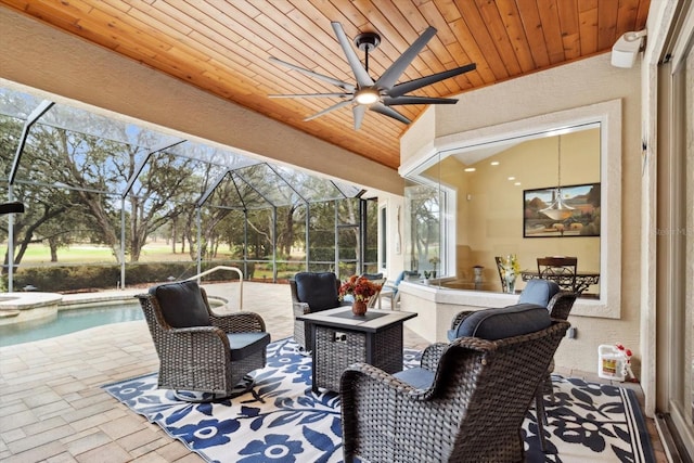 view of patio featuring a pool with hot tub and a lanai