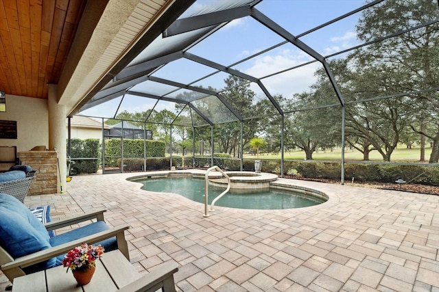 view of swimming pool featuring an in ground hot tub, glass enclosure, and a patio area