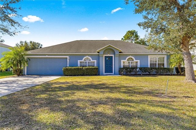 ranch-style home featuring a garage and a front yard