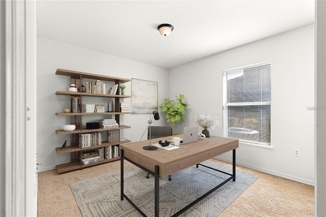 office featuring light colored carpet and a textured ceiling