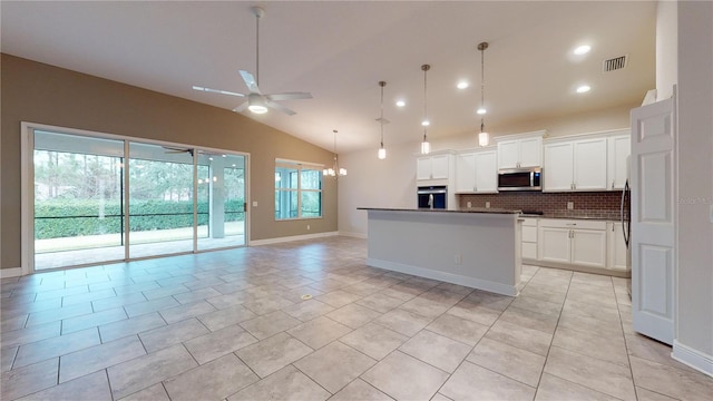 kitchen featuring hanging light fixtures, appliances with stainless steel finishes, white cabinets, and ceiling fan