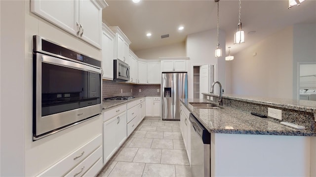 kitchen with white cabinetry, appliances with stainless steel finishes, sink, and hanging light fixtures