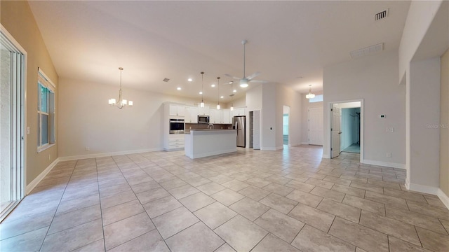 unfurnished living room featuring light tile patterned flooring, high vaulted ceiling, and ceiling fan with notable chandelier