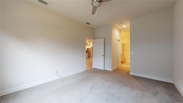 unfurnished bedroom featuring light carpet, ceiling fan, and a closet