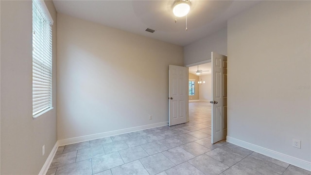 tiled empty room with ceiling fan