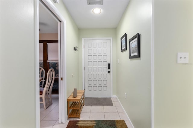 doorway with light tile patterned flooring