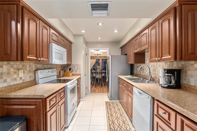 kitchen featuring light tile patterned floors, sink, white appliances, and backsplash