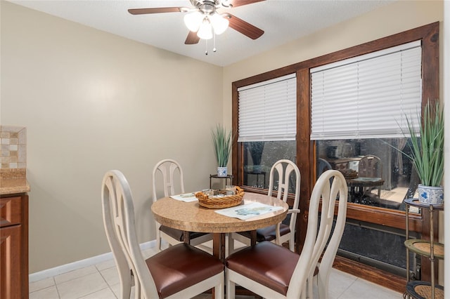 dining room with ceiling fan and light tile patterned flooring