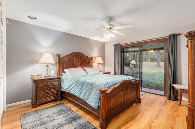 bedroom featuring a textured ceiling, ceiling fan, access to exterior, and light hardwood / wood-style floors