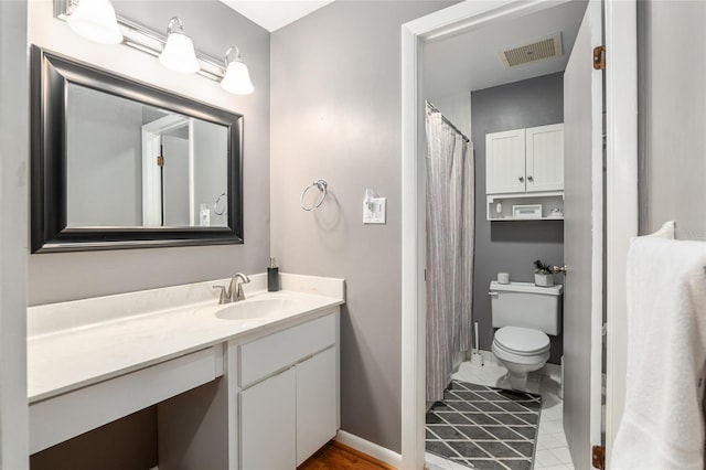 bathroom with toilet and vanity