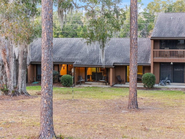 view of front of house featuring a front lawn and a patio area