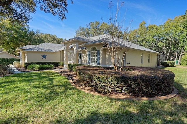 view of side of property with a lawn