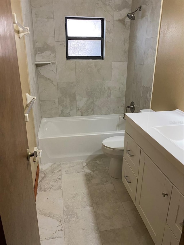 full bathroom featuring toilet, vanity, and tiled shower / bath