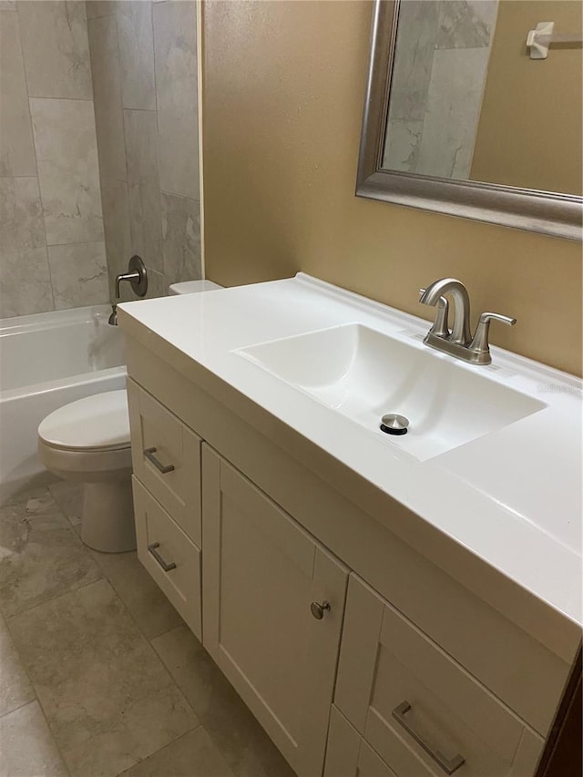 full bathroom with toilet, vanity, and tiled shower / bath combo