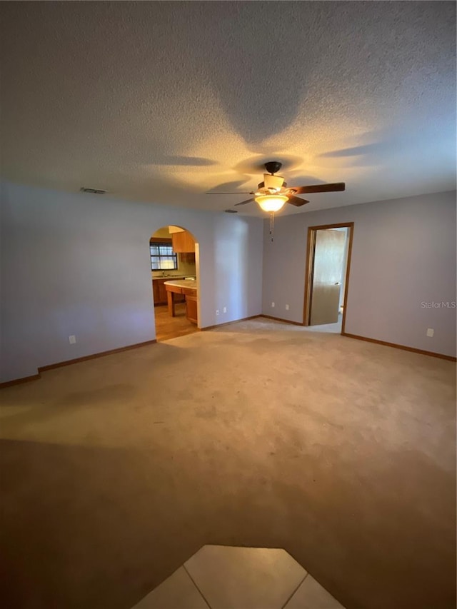 carpeted empty room with ceiling fan