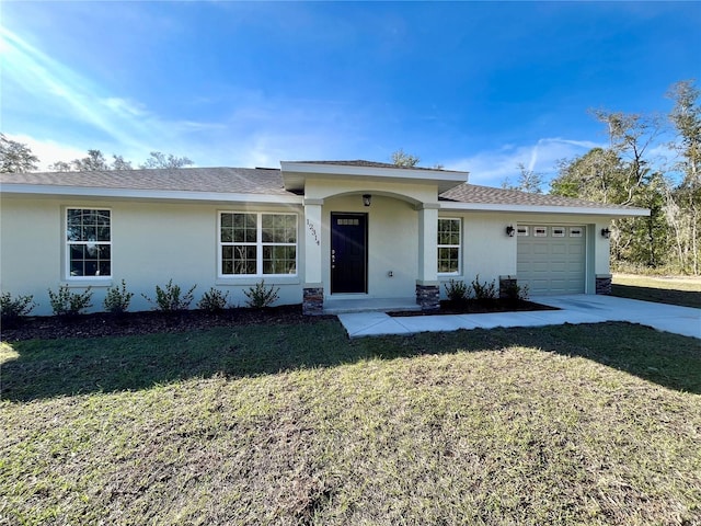 single story home featuring a front lawn and a garage