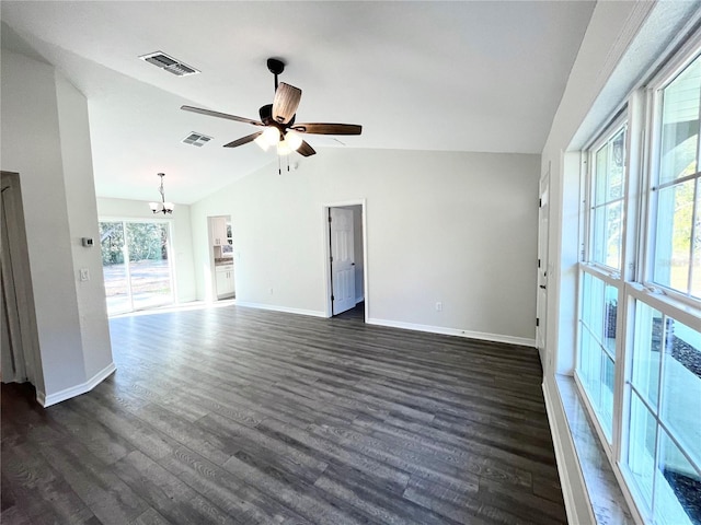 unfurnished living room featuring vaulted ceiling, dark wood-type flooring, and ceiling fan with notable chandelier