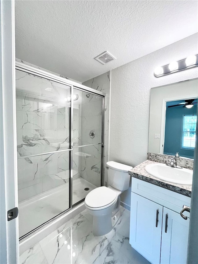 bathroom with walk in shower, vanity, toilet, and a textured ceiling