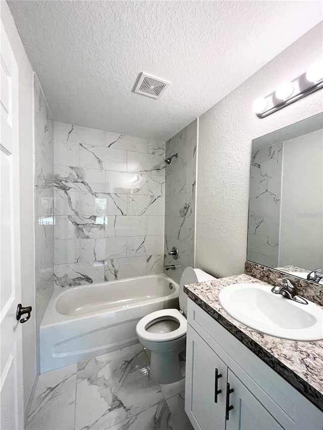 full bathroom with toilet, tiled shower / bath, vanity, and a textured ceiling