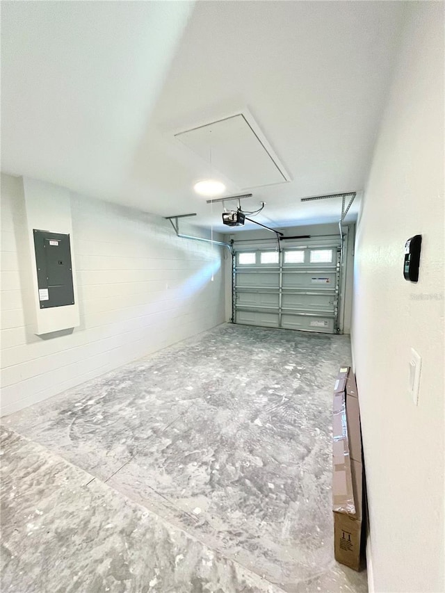 garage with a garage door opener and electric panel