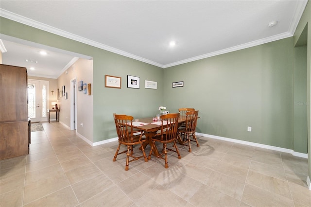 tiled dining area featuring crown molding