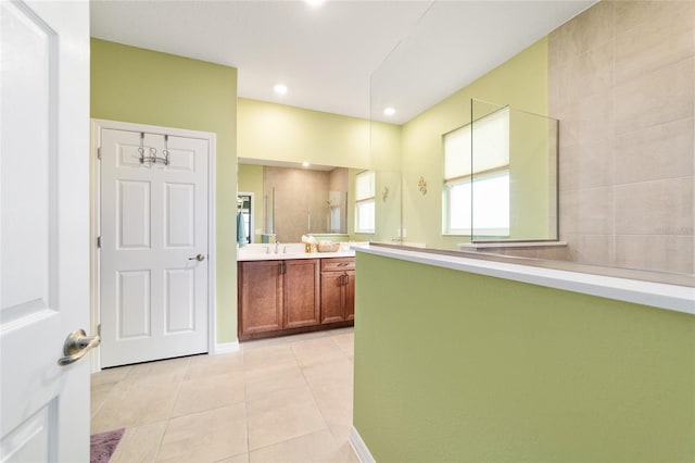 bathroom with vanity, walk in shower, and tile patterned flooring