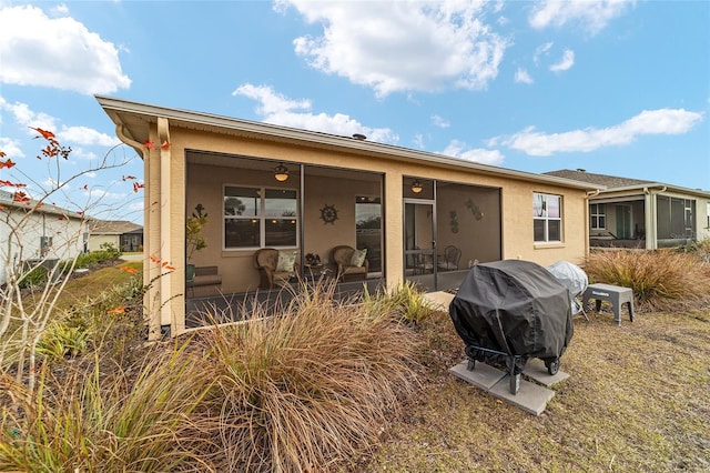 back of house featuring a sunroom